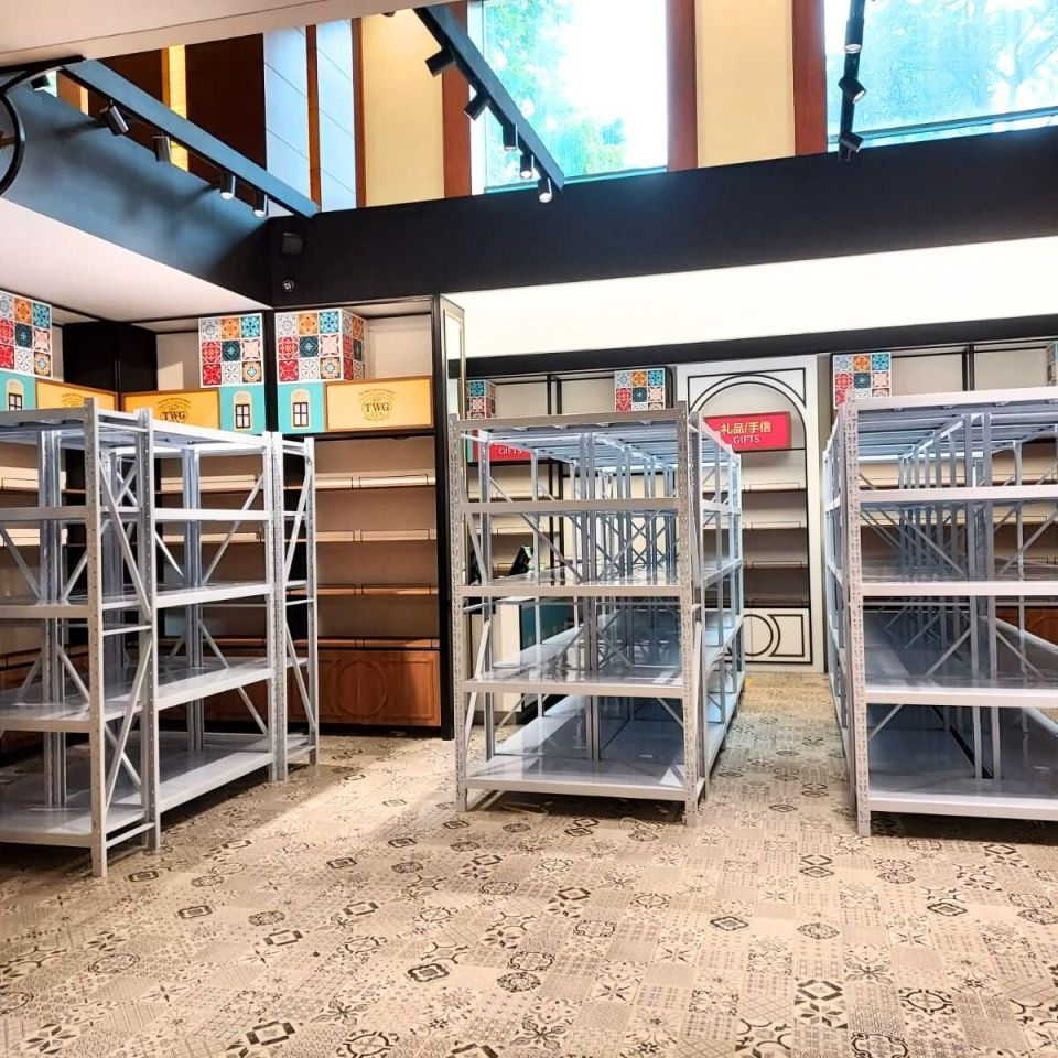 White boltless racks installed in a library store with patterned carpet