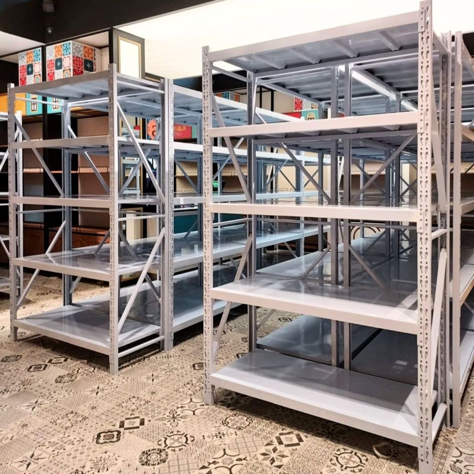 White boltless racks with steel shelves set up in a commercial storage room